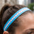 Person wearing a blue headband with red star patterns outdoors