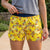 Person wearing yellow shorts with duck pattern outdoors
