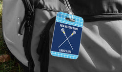 Personalized girls lacrosse bag tag with crossed sticks and player name on a navy and light blue net background.