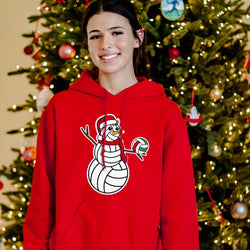 Girl wearing red volleyball hoodie
featuring a snowman made of volleyballs in front of a Christmas tree.