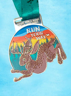 Medal with a jackalope design and 'Run Your Way 5K' text on a blue background