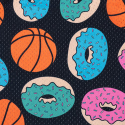 A repeating pattern of colorful donuts and basketballs on a dark navy background with fine vertical lines. The donuts have pink, teal, and blue frosting with multicolored sprinkles, and the basketballs are orange with black seams.