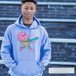 Person wearing a blue hoodie with a pink ice cream cone character holding a baseball bat design.