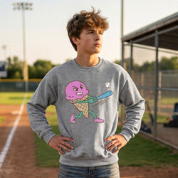 Person wearing a gray sweatshirt with a colorful ice cream cone character design on a baseball field.