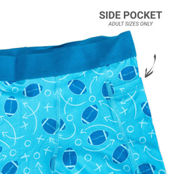 Blue shorts with football pattern and side pocket feature on a white background