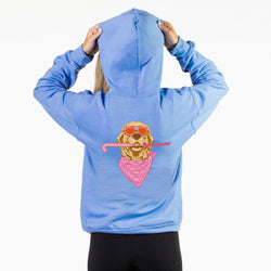A person shown from the back wearing a light blue hoodie with a graphic of a golden retriever wearing sunglasses and a pink bandana holding a pink field hockey stick.