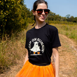 Halloween running outfit featuring a black "Creep on Runnin" t-shirt and orange tutu skirt.