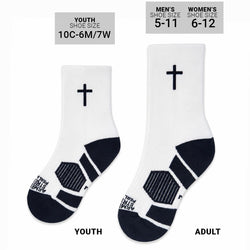A pair of white crew socks with navy blue accents, featuring a simple black cross on the upper calf and navy blue panels on the heel and toe with wording on the toe