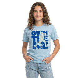 Person wearing a light blue t-shirt with a hockey graphic design on a white background