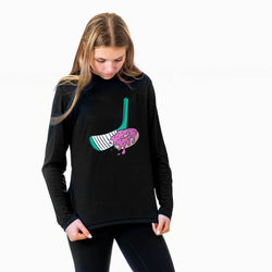 Woman wearing a black sweatshirt with a colorful hockey stick and donut graphic design on a white background