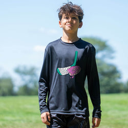 Child wearing a black long-sleeve shirt with a donut graphic design outdoors