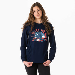 Girl wearing a navy blue long-sleeve shirt with a hockey graphic design on a white background