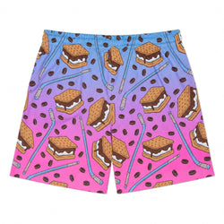 A pair of men's shorts featuring a vibrant gradient background that transitions from light blue at the top to bright pink at the bottom, decorated with a repeating pattern of hockey pucks, blue hockey sticks, and brown graham cracker s'mores with white cream filling.