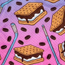 A repeating illustrated pattern on a pink background featuring graham cracker s'mores with chocolate and white cream filling, hockey pucks, and blue hockey sticks