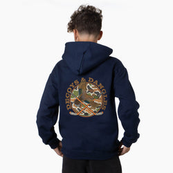 A boy viewed from behind wearing a navy sweatshirt with a large graphic on the back. The graphic features the words 'DECOYS & DANGLES' in a tan font surrounding a camouflage-patterned circle with a duck and crossed hockey sticks