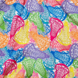 A close-up of colorful lacrosse sticks with mesh heads in pink, blue, green, orange, yellow, and purple, printed on a white fabric background.