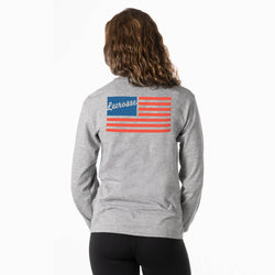 Person wearing a gray long-sleeve shirt with a red, white, and blue usa lacrosse flag design on the back.