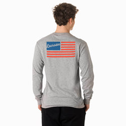 Person wearing a gray long-sleeve shirt with a lacrosse-themed American flag design on the back.