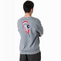 Person wearing a gray sweatshirt with a lacrosse graphic design on the back, standing against a white background