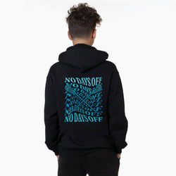 A person viewed from behind wearing a black hoodie with a large turquoise graphic on the back. The graphic features the text 'NO DAYS OFF' repeated in a grid pattern with crossed hockey sticks running through it.