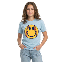 Person wearing a light blue t-shirt with a softball smiley face design on a white background