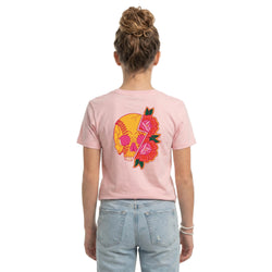 Person wearing a pink t-shirt with a colorful softball skull graphic design on the back, standing against a white background.