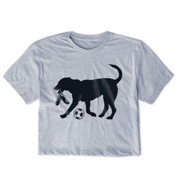 Gray t-shirt with a black silhouette of a dog playing with a soccer ball and cleats on a white background