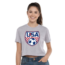 Woman wearing a gray t-shirt with USA soccer design on a white background