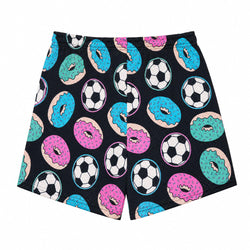 Black athletic shorts featuring a colorful pattern of pink, blue, and teal frosted donuts and black-and-white soccer balls, shown flat against a white background.