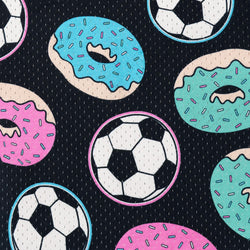A repeating pattern featuring soccer balls and donuts on a dark navy background with fine vertical stripes. The donuts are pink, blue, and mint green with white sprinkles, and the soccer balls are black and white.