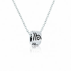 A silver pendant necklace featuring a cylindrical charm with black engraved abstract swirl patterns, suspended on a delicate silver chain against a white background with a soft reflection.