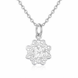A silver necklace featuring a circular, filigree-style pendant with the words 'Sole Sister' cut out, suspended from a classic curb chain on a white background.