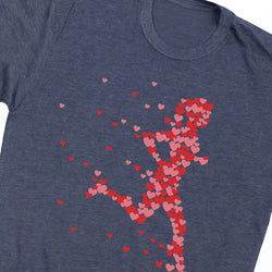 A close-up of a heather navy blue t-shirt featuring a graphic of a running figure formed by red and pink hearts.