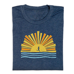 Folded navy blue t-shirt with a sun and wave design on a white background