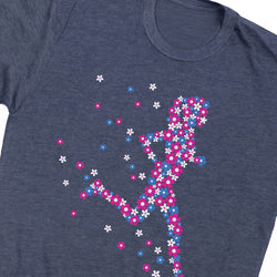 A close-up of a heather navy blue t-shirt featuring a colorful graphic of a running figure made of pink, blue, and white flowers.