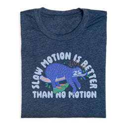 Folded blue t-shirt with a sloth graphic and text 'Slow motion is better than no motion' on a white background