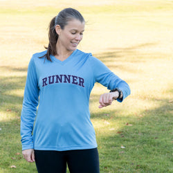 Woman wearing a blue 'RUNNER' shirt outdoors
