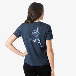 Person wearing a navy blue t-shirt with a colorful star runner design on the back against a white background