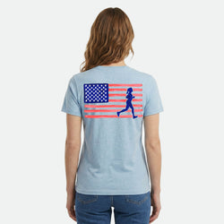 Light blue t-shirt with American flag and running woman graphic on the back, worn by a person.