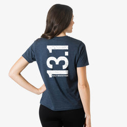 Person wearing a blue t-shirt with '13.1 Half Marathon' printed on the back.