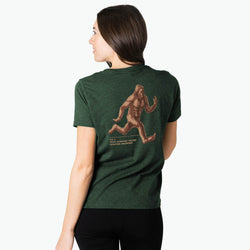 Person wearing a green t-shirt with 'bigfoot' design on the back.