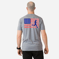 Person wearing a gray t-shirt with an American flag and running figure design on the back.