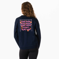 A woman viewed from behind wearing a navy blue sweatshirt with a pink and orange graphic text print on the back, paired with black leggings, against a plain white background.