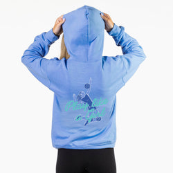 A person shown from the back wearing a light blue heathered hoodie with a graphic of a lacrosse player and the text 'Play like a girl' in teal and dark blue on the back, paired with black leggings against a plain white background.