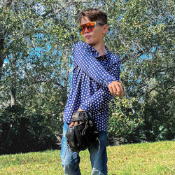 Youth blue long sleeve shirt featuring all-over white baseball pattern worn with fielding glove