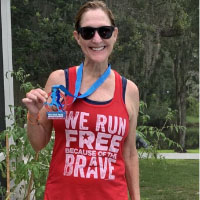 Red "We Run Free Because of the Brave" tank top with a patriotic virtual race medal
