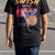 Boy wearing a black basketball t-shirt featuring Swish Happens slogan and ball in net graphic on the back.