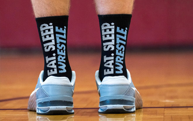 Person wearing socks with 'Eat