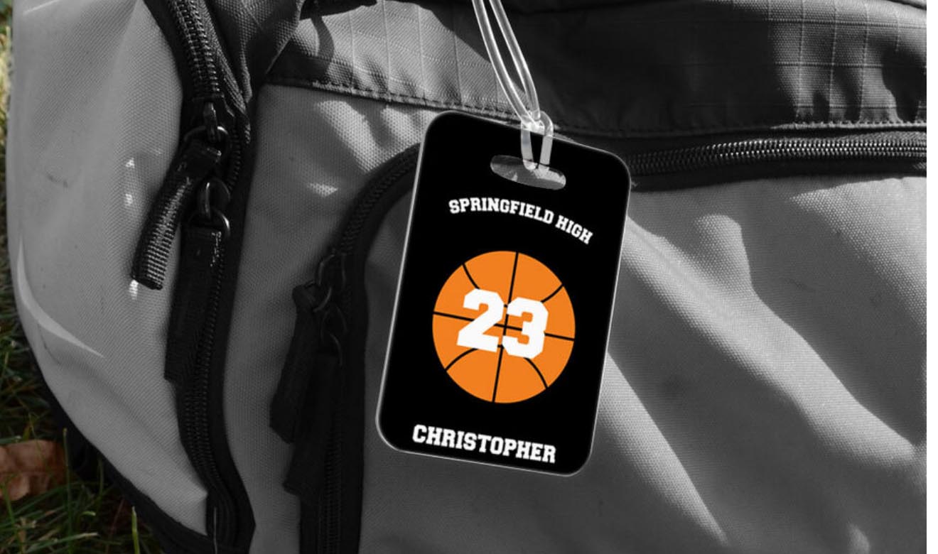Personalized basketball bag tag with an orange basketball graphic, player number, and name on a black background