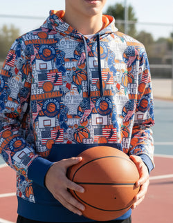 Youth wearing a performance basketball hoodie featuring a pattern of American flags, skeletons, hoops, and Eat Sleep Basketball text.